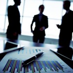 Shadowy business trio holding a briefing concerning the reported statistic data