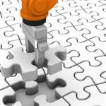 Robot holding jigsaw puzzle piece on a white background.