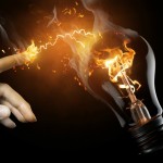 a woman pointing to the illuminated bulb