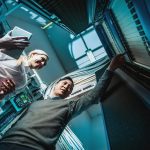 Young engineers businessmen in server room