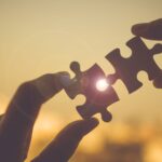 silhouette-woman-hands-connecting-couple-puzzle-piece