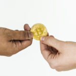Closeup of exchanging bitcoin isolated on white background