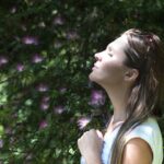 Photo by Alex P: https://www.pexels.com/photo/woman-closing-her-eyes-against-sun-light-standing-near-purple-petaled-flower-plant-321576/