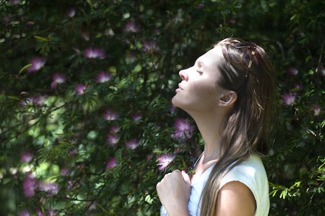 Photo by Alex P: https://www.pexels.com/photo/woman-closing-her-eyes-against-sun-light-standing-near-purple-petaled-flower-plant-321576/