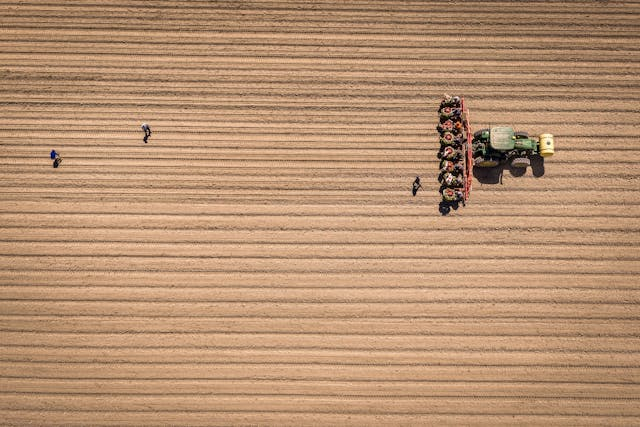 Photo by Mark Stebnicki: https://www.pexels.com/photo/aerial-view-of-plowed-field-with-tractor-and-workers-37201225/